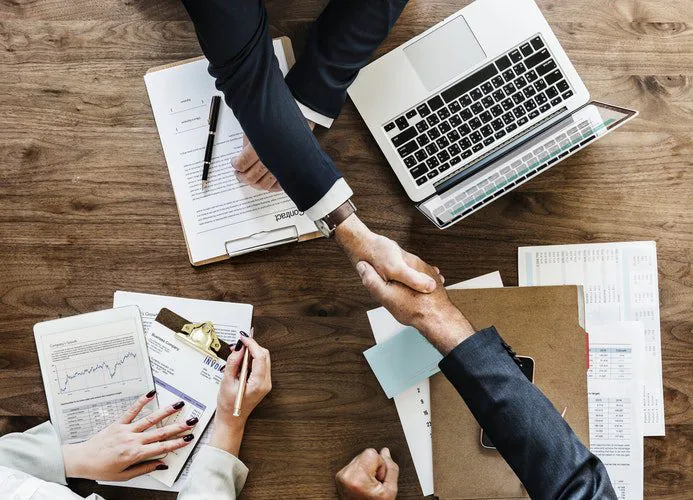 Tax advisers reviewing financial documents at a conference table