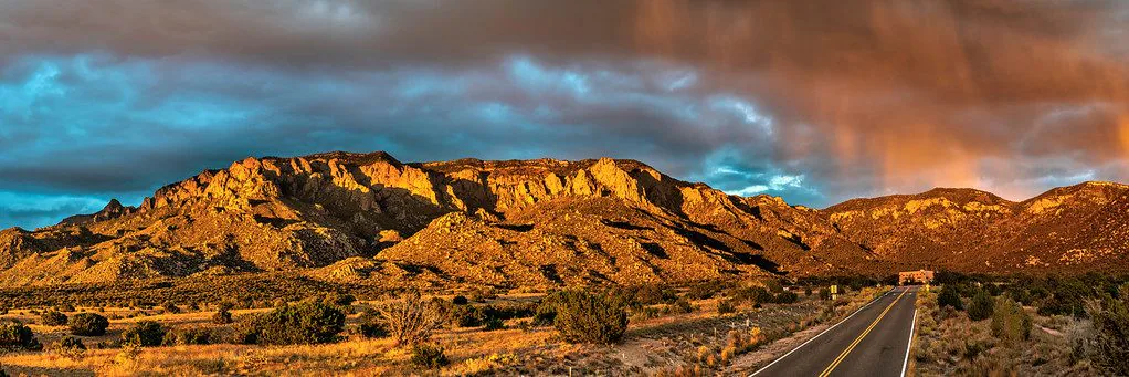 New Mexico desert mountains beneath dramatic clouds